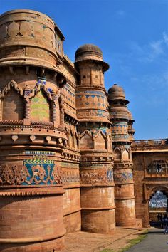 an old brick building with ornate designs on it's sides and arches in the middle