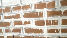 a brick wall with white paint on it