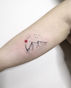 a person's arm with a small tattoo on the left side of their arm