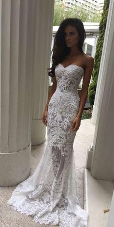 a woman in a white wedding dress posing for the camera