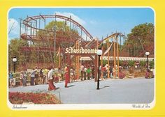 an amusement park with people standing in front of it