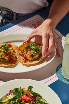 a person reaching for some food on a plate