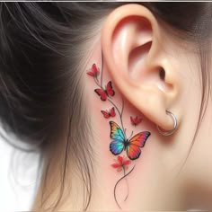 a woman's ear with colorful butterflies on it