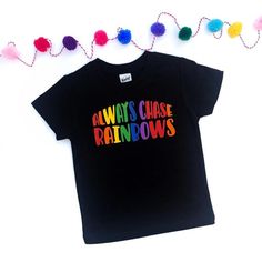 a black t - shirt with the words always chase rainbows written in multicolored letters