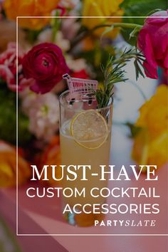 a glass filled with lemonade and garnish on top of a table next to flowers