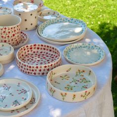 a table topped with lots of plates and bowls