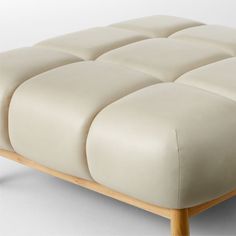 Designed by goop, the Sevigne leather ottoman invites low-slung lounging. Inspired by midcentury Italian modernism with a twist, our version is lifted entirely off the ground by American white oak legs certified sustainable by the Forest Stewardship Council r FSC for a lighter, fresher silhouette. Supple leather upholstery in a custom bone color and channel tufting softens the grid of ultra-plush cushioning. An unlacquered brass andamp;quot;gandamp;quot; medallion on the front leg for a refined Italian Modernism, White Leather Ottoman, Navy Velvet Chair, White Wood Furniture, Velvet Furniture, China Dinnerware Sets, Brass Furniture, Bone China Dinnerware, Chair Options