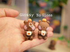 there are three small bears that have been placed in someone's hand with the words glossy no glosss on them