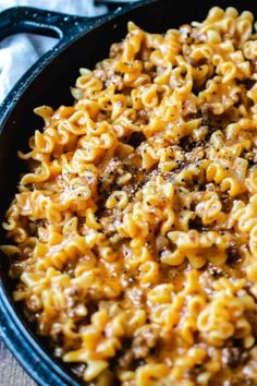 hamburger helper lasagna in a skillet with text overlay that says hamburger helper lasagna