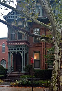 an old victorian style house is shown in the fall