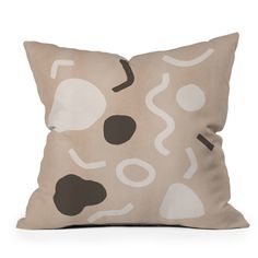 a beige pillow with black and white shapes on it