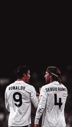 two soccer players standing next to each other