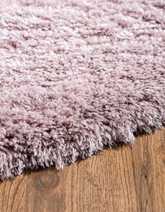 a close up view of a rug on a wooden floor