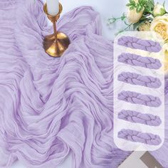 the purple blanket is next to a gold candle and some flowers on a white table