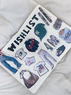 a book with various items on it sitting on a sheet of white paper that says wishlist