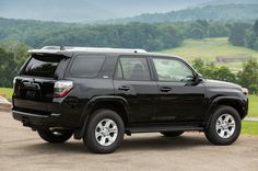 a black toyota 4runner is parked on the road