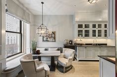 a kitchen and dining room with white cabinets