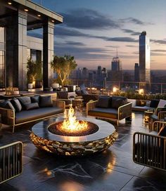 a fire pit sitting on top of a patio next to couches and tables in front of a city skyline