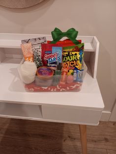 a white table topped with lots of different types of items on top of each other