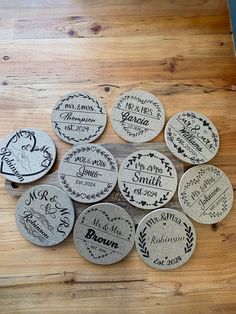 six personalized cork coasters on a wooden table