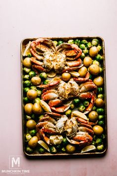 lobsters, potatoes and peas on a baking sheet