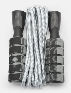 two pairs of black and white shoelaces on top of each other, with one pair in the middle