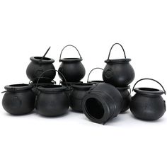 twelve black cast iron caulders with handles and lids, each holding a small pot