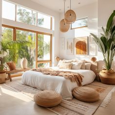 a large bed sitting inside of a bedroom next to two planters and a window