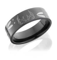 a black ring with white fish engraved on it