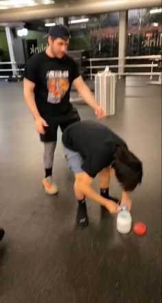 two people are playing with a frisbee in an airport