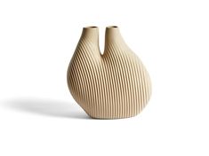 two wooden vases sitting side by side on a white surface, one with wavy lines