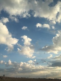 the sky is filled with white clouds and blue skies