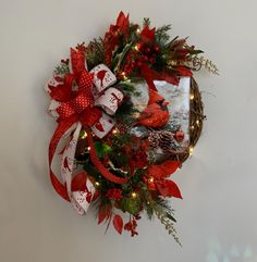 a christmas wreath with cardinals and pine cones