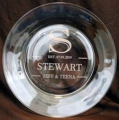 a clear glass plate with the name stewart on it and a monogrammed logo