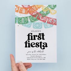 a person holding up a card with the words first fiesta on it