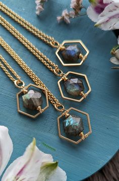 "This simple, layering necklace features a faceted, hexagon-shaped Labradorite gem within a satin gold Hexagon frame.  The stones are dark with flashy green, teal, and/or blue when the light hits them.  (If you have a preference on the color of flash, please either message me or leave a note in the Note to Seller section at checkout.) The pendant measures just shy of 1\" long x .75\" wide on a satin gold-plated rolo chain with a satin gold lobster claw clasp.  You may choose your preferred length of chain: 16\", 18\", 20, or 22\".  (If you would prefer a different length, just message me!  I'd be happy to accommodate!) The chain is electro-plated, solid brass, and nickel-free. Thanks for checking out the shop and feel free to drop me a line if you have any questions!" Minimalist Faceted Octagon Jewelry, Minimalist Octagon Faceted Jewelry, Minimalist Hexagon Faceted Jewelry, Hexagon Faceted Necklace For Gifts, Hexagon Gemstone Necklace As A Gift, Faceted Hexagon Necklace For Gifts, Hexagon Gemstone Necklace For Gift, Hexagonal Gemstone Necklace As Gift, Hexagon Faceted Necklace For Gift