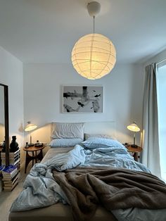 a bedroom with a large bed covered in blankets