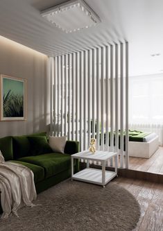 a living room with a green couch and white coffee table in front of a striped wall