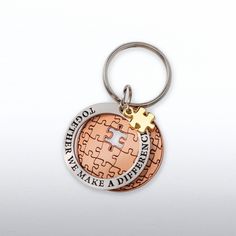 a metal keychain with a puzzle piece on it that says, we take a deep breath