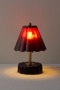 a red lamp sitting on top of a table