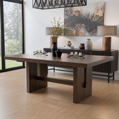 a large wooden table with two vases on it