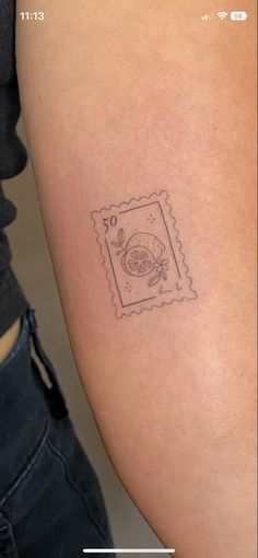 a woman's arm with a small tattoo on the left side of her arm