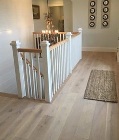 a staircase with white railings and candles on the bannister balconies