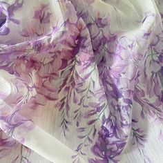 the fabric has purple flowers on it