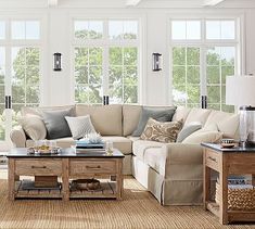 a living room filled with furniture and windows