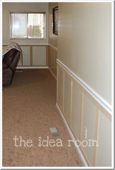 an empty room with a bed, chair and window on the far wall in it