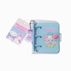 a hello kitty notebook with a keychain attached to it