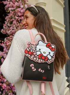 Bow obsessed and always looking your best! The Hello Kitty Bow Backpack keeps you stylish on the go. Featuring a sleek black base with contrasting pink edge paint. The front flap showcases Hello Kitty herself in a white sequin fabric, and a bouquet of bows in plaids, shimmer, and weave fabrics. Keep all your essentials at hand by using the interior pocket, and adventure with ease using the adjustable straps. Made of faux/vegan black and pink leather with an interior Hello Kitty bow polyester lin Bow Bouquet, Hello Kitty Bow, Hello Kitty Bag, Cute Hello Kitty, Danielle Nicole, Hello Kitty Pink, Girly Bags, Bow Pattern, Hello Kitty Items