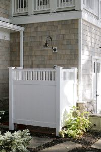 a white fence in front of a house