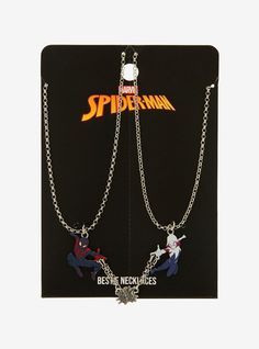 two spider - man necklaces are on display in front of a black card case